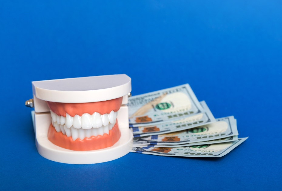 Dental model with clear aligned teeth beside US dollar bills representing clear aligners cost and treatment pricing in the USA.