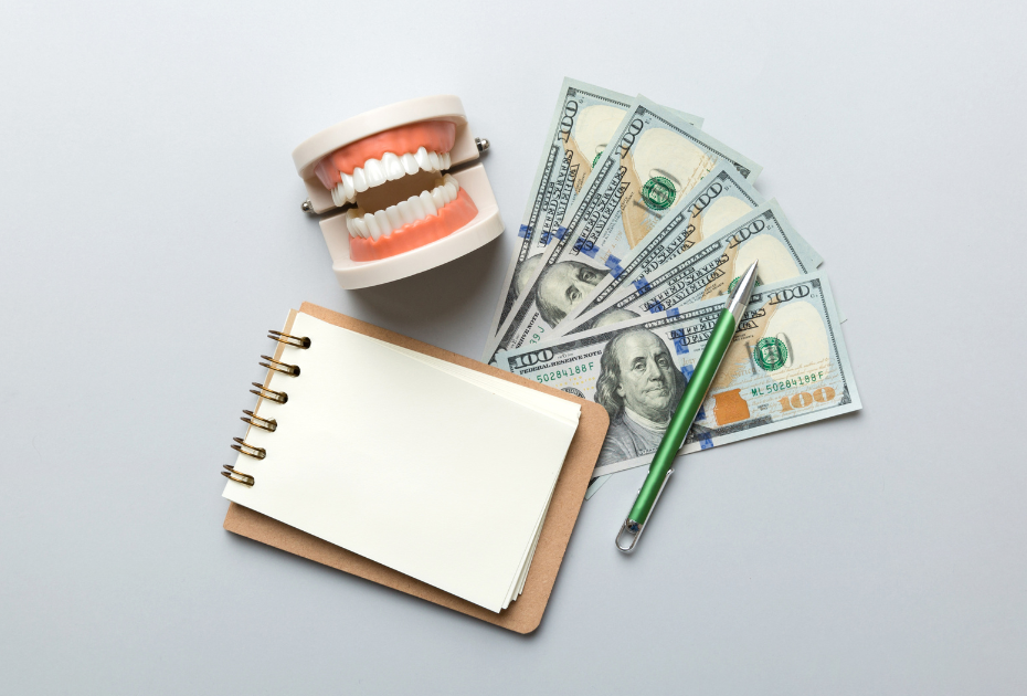 Clear aligners monthly payment concept with dental model, US dollar bills, notebook, and pen representing affordable teeth aligner financing options.