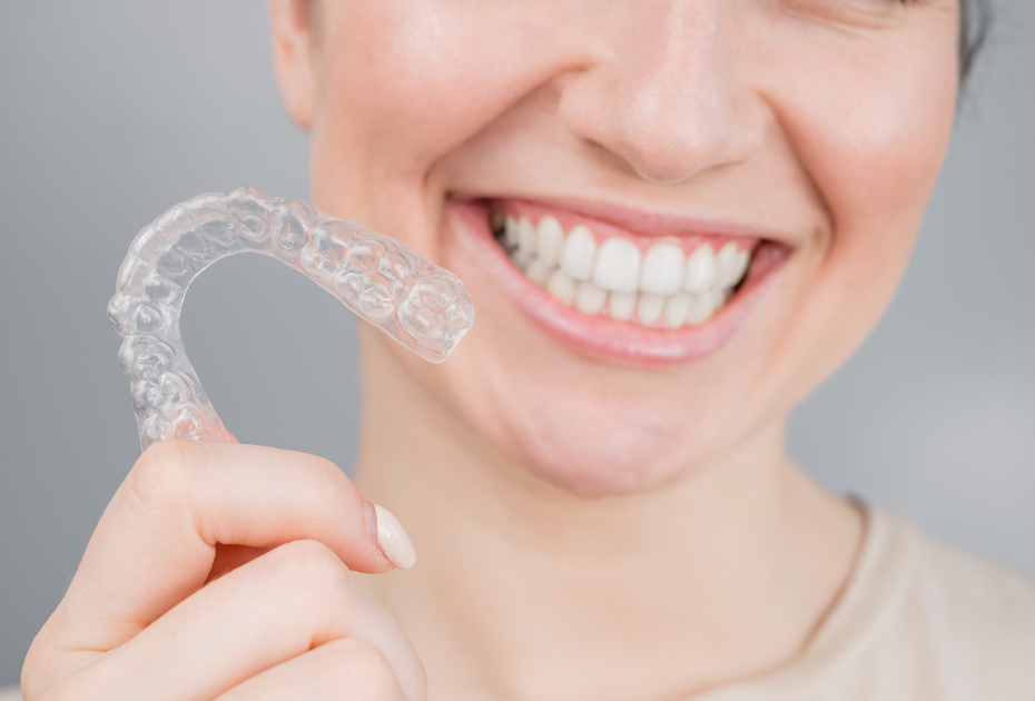 Clear aligner treatment plan preview with transparent aligner trays and a confident smile