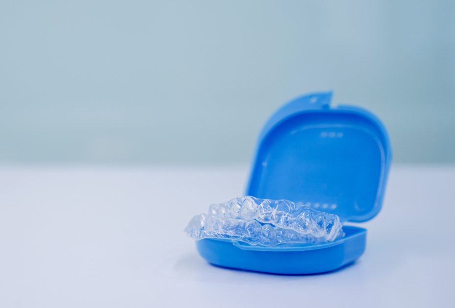 Clear aligners stored in a blue protective case to prevent damage and maintain proper aligner storage hygiene.