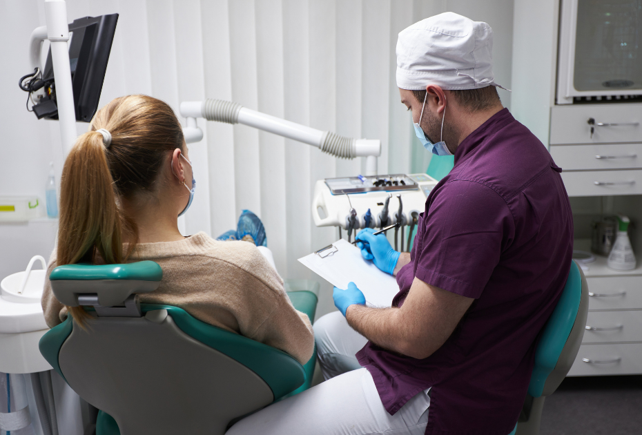 Dentist explaining clear aligner treatment plan to patient during consultation. 
