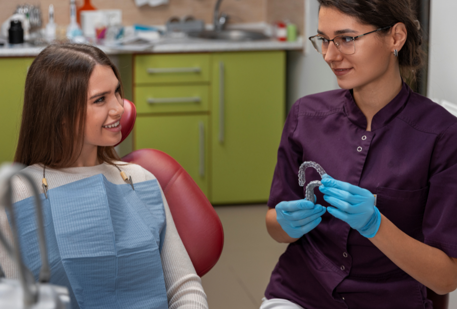 Dentist explaining clear aligners to a patient during a clear aligners consultation.