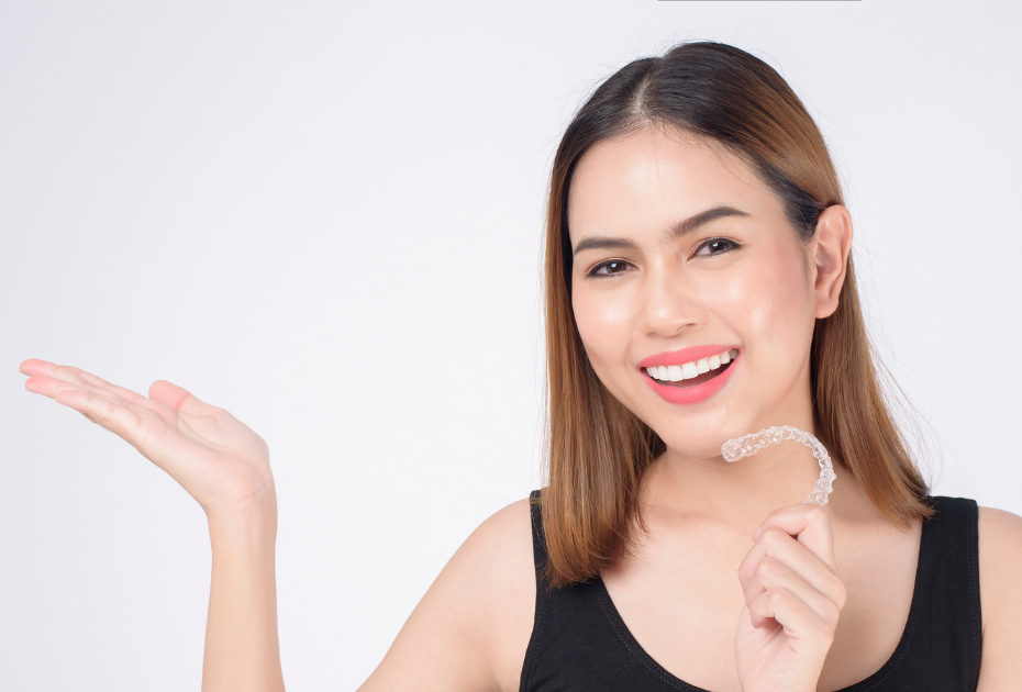 Woman with clear aligner tray demonstrating start of clear aligners USA process.