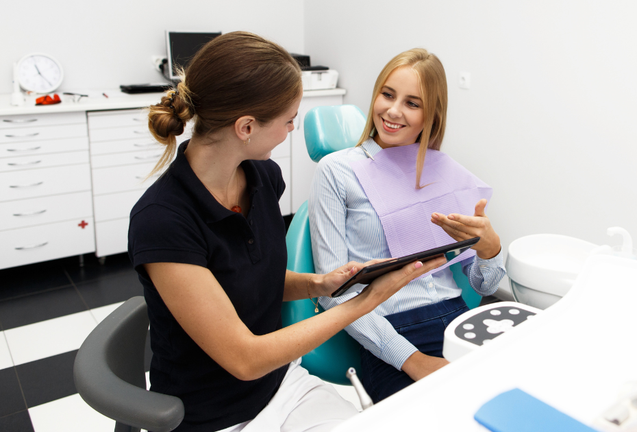 Woman consulting with a dentist about invisible braces treatment during an orthodontic appointment.