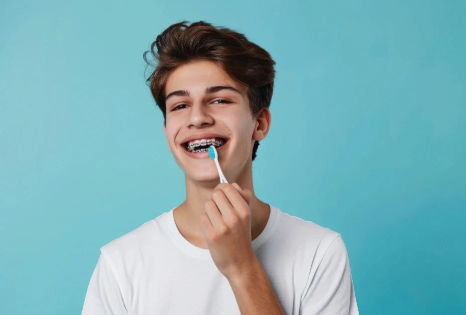 Person brushing teeth with metal braces for oral hygiene